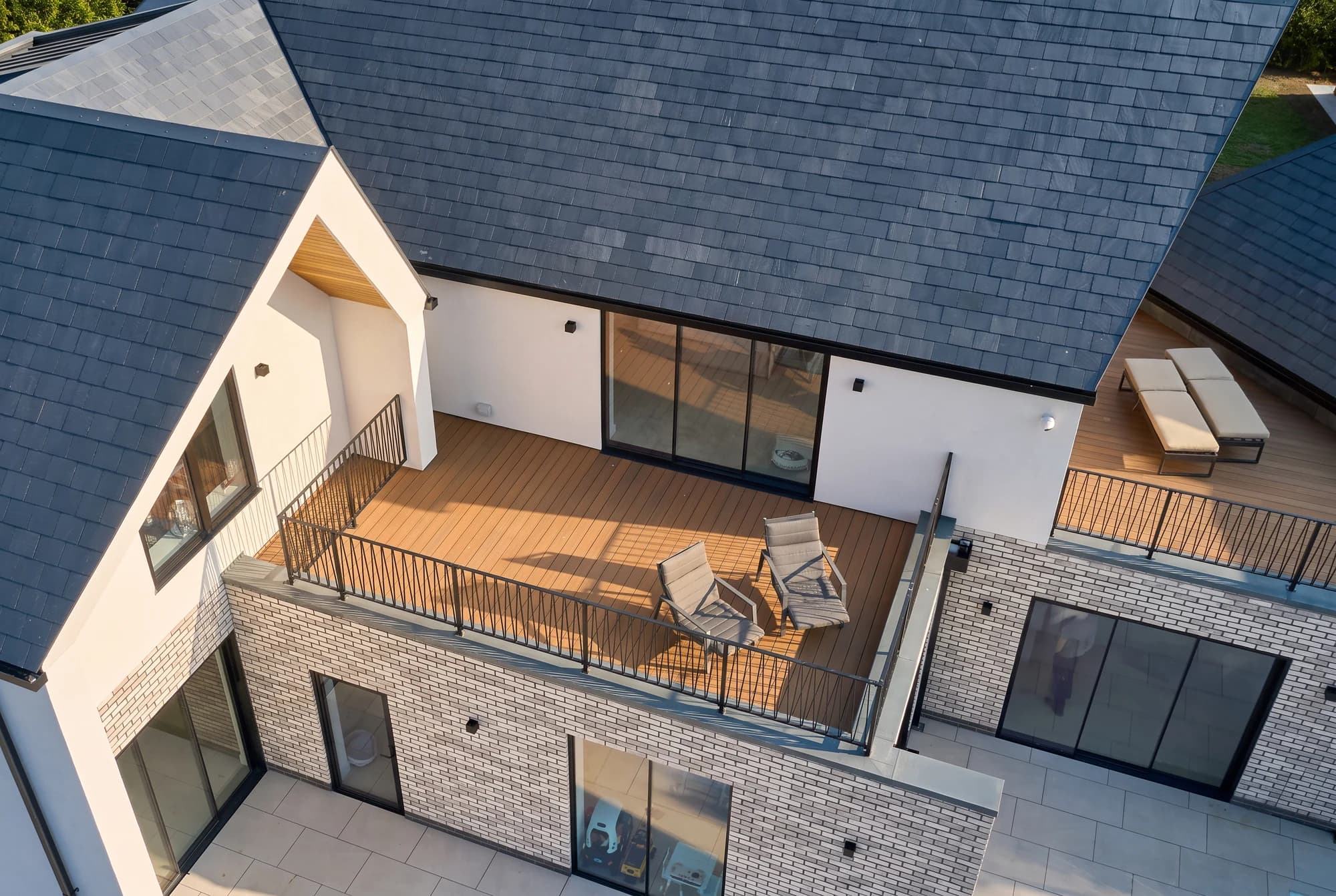 Upper terrace with timber decking and black metal railings